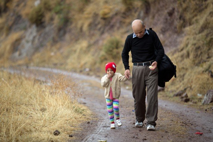 A man walks across Lesbos Island, Greece, with his granddaughter. Along the way, they received bananas and water from Samaritan’s Purse.
