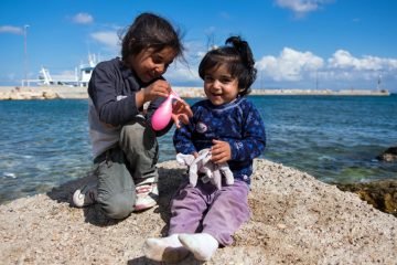 Refugee children still play and laugh despite the difficulties they and their families face.