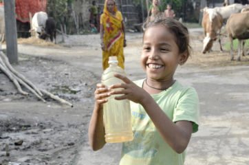 A Nepalese girl collects clean water provided by Samaritan's Purse