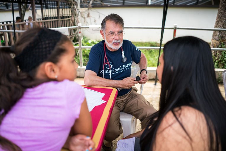 Dr. Carlos de la Garza listened with compassion as he saw patients with a variety of ailments.