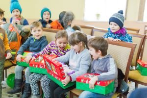 Children exploring shoebox gifts