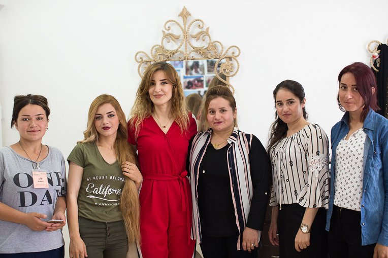 Sarina (second from left) and Marwa (third from left) with ladies in the Northern Iraq Community Centre salon.