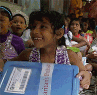 Girl reacts to opening shoebox gift