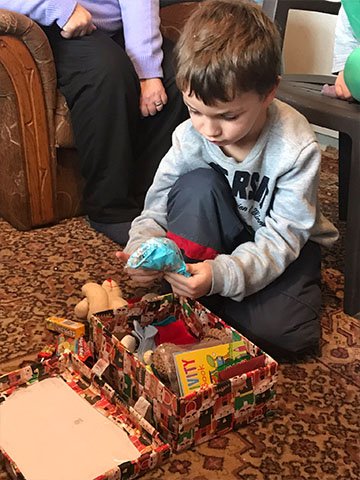 Boy explores shoebox gift