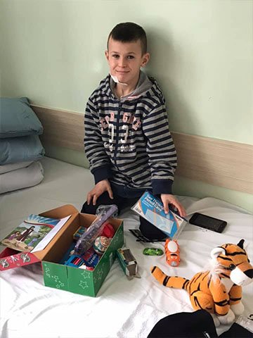 Boy in hospital with shoebox gift