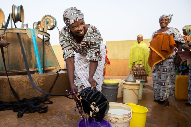 A woman in Niger gathers water at a well installed by Samaritan’s Purse.