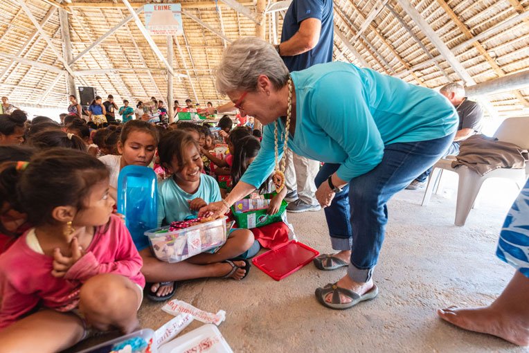 JANE GRAHAM DELIVERS GIFTS AS WELL DURING AN OUTREACH EVENT IN THE PACIFIC ISLANDS.
