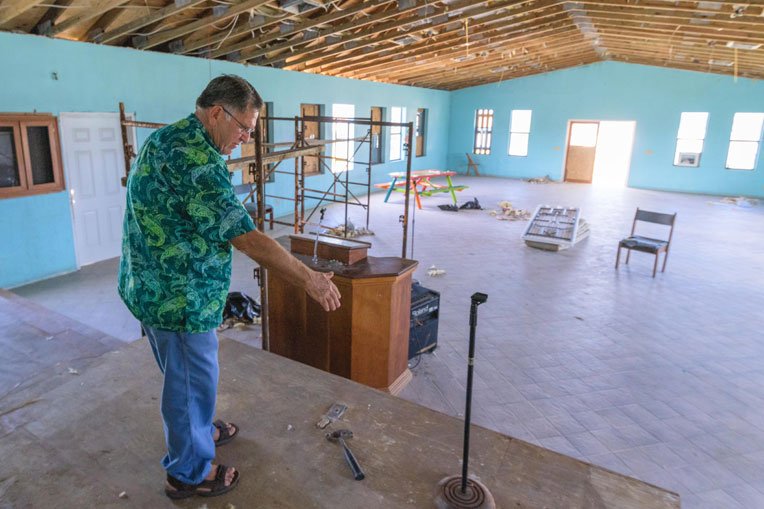 Pastor Robinson Weatherford points out the repairs that Samaritan’s Purse did to the sanctuary of International Gospel Mission.