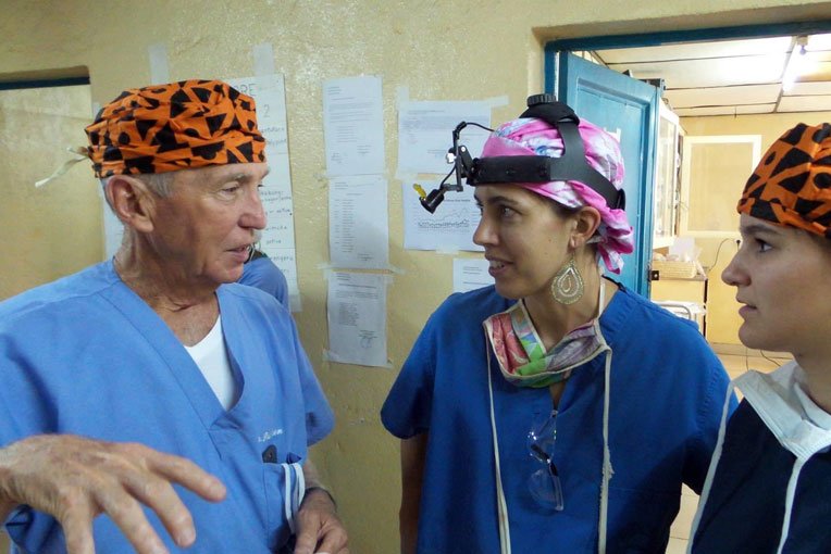 Dr. Richard Furman and his granddaughter visit with former post-resident Dr. Rachel McLaughlin (center). She now serves long-term at Kibuye Hope Hospital in Burundi.
