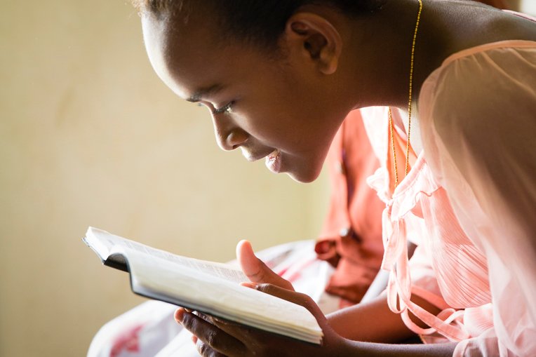 This participant in The Greatest Journey discipleship program in Fiji pores over the Bible she received at graduation.