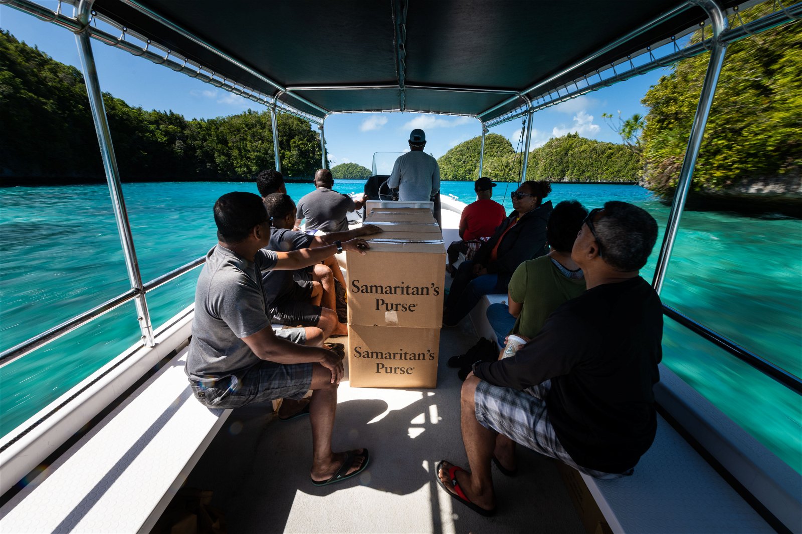 SHOEBOX GIFTS TRAVEL BY CHARTERED BOAT FROM KOROR THROUGH THE ROCK ISLANDS TO PELELIU FOR THE FIRST OUTREACH EVENT IN PALAU.