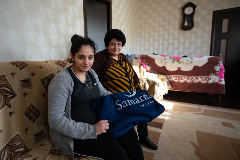 Lisa, left, and Nasely fled their home with little more than the clothes they were wearing. Blankets and other winter supplies will protect against the already-harsh winter months.