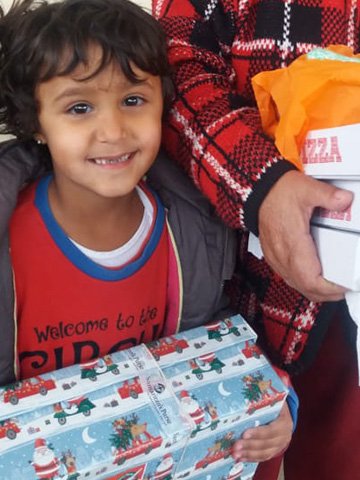 Boy smiles with shoebox gift