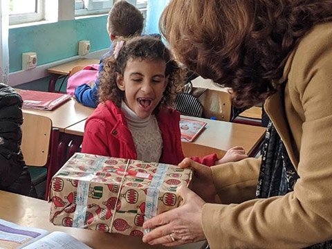 girl open mouthed at shoebox gift