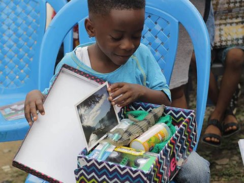 Boy with shoebox in Nigeria