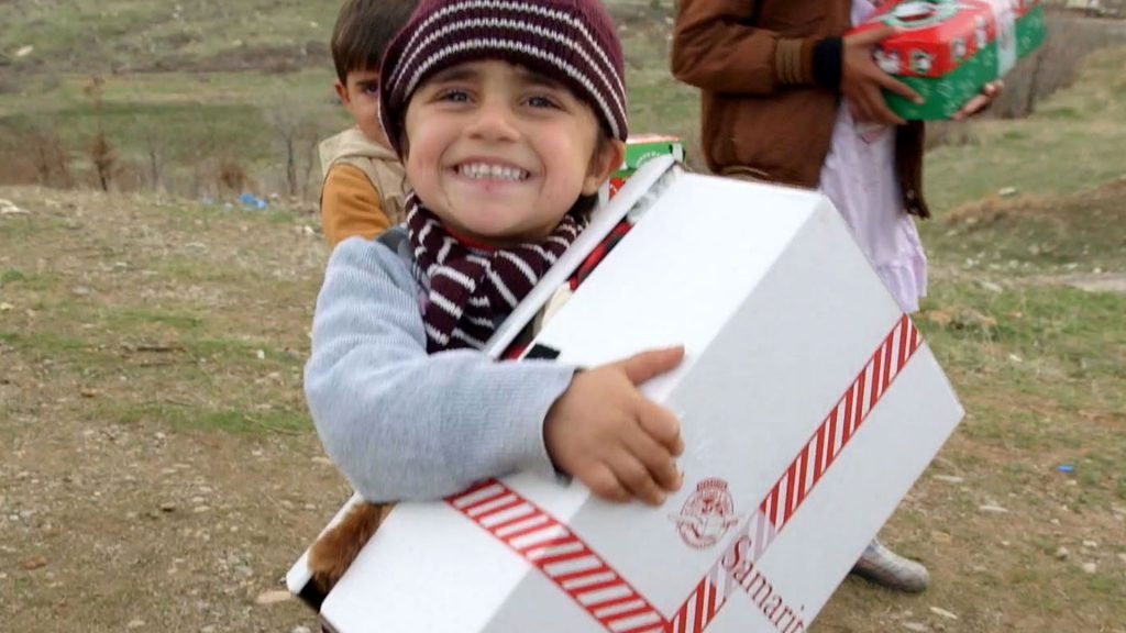 Refugee holding shoebox