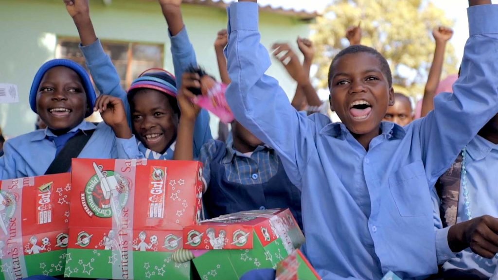 Boys cheer in Zimbabwe at shoebox outreach event