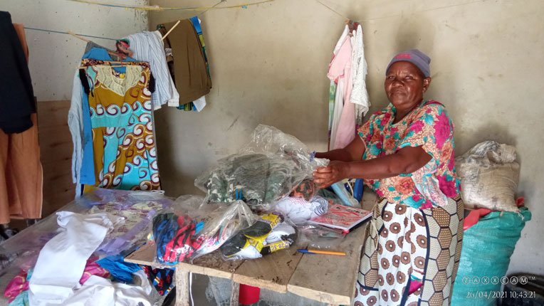 Rhoda has earned money selling goats, allowing her extra income for her sewing business.