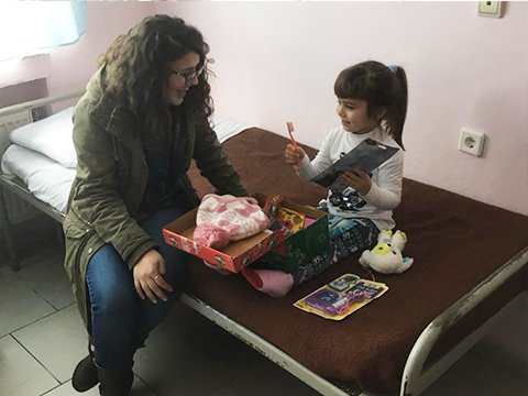 Young girl in hospital with shoebox gift