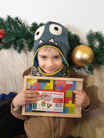Boy in monster hat holding tetris game