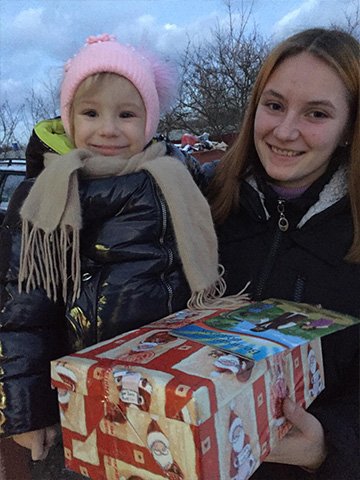 Mother and daughter with shoebox gifts