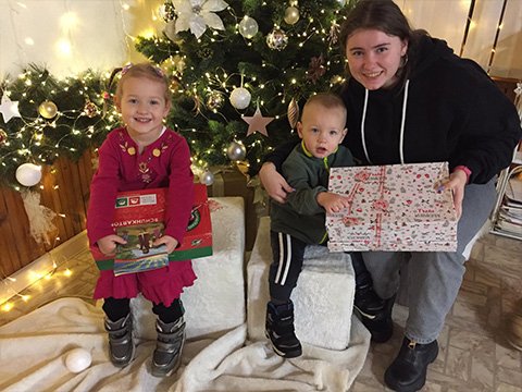 family with shoebox gifts