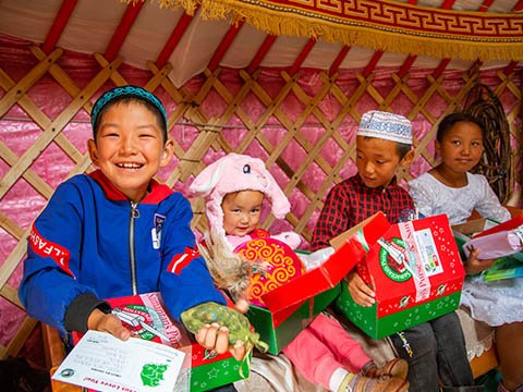 Family in mongolia opening shoebox gifts