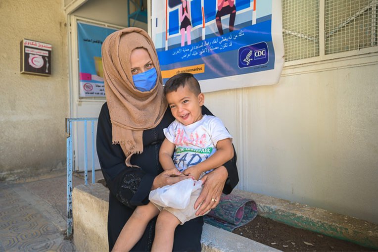 Hana, pictured here with her son, is expecting her first daughter and receiving prenatal care at the clinic.