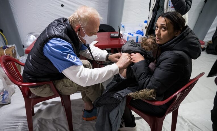 One of our doctors attends to a sick child with his mother at the train station clinc.