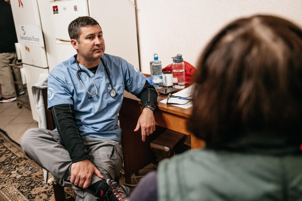 Dr. Mark Hilliard consults with patients at the Samaritan’s Purse Mobile Medical Clinic in partnership with Resurrection Church in Lviv, Ukraine.