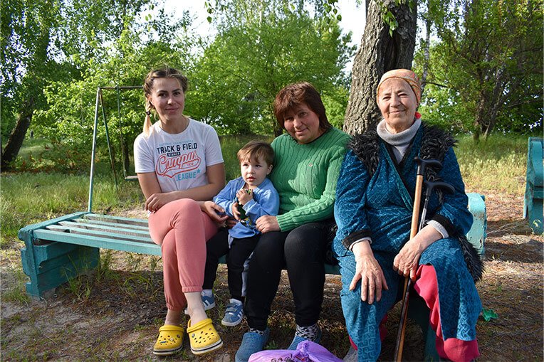 Oksana (second from right) and her family were left with nowhere to purchase groceries when shops in their town closed down.