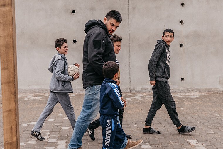 Mark Dagher enjoys a walk with some of the young residents of the Yazidi Empowerment Project.