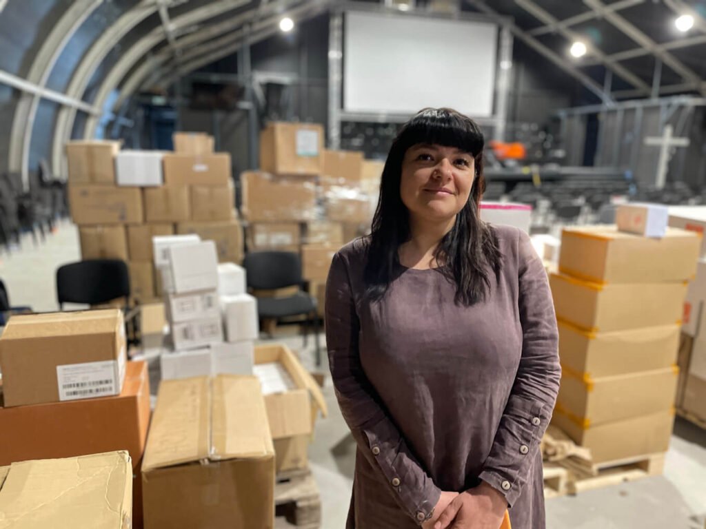 Dr. Alla Mustafaieva, a local physician and member of a partner church, stands amazed amid the hundreds of boxes of medical supplies warehoused on the church property.