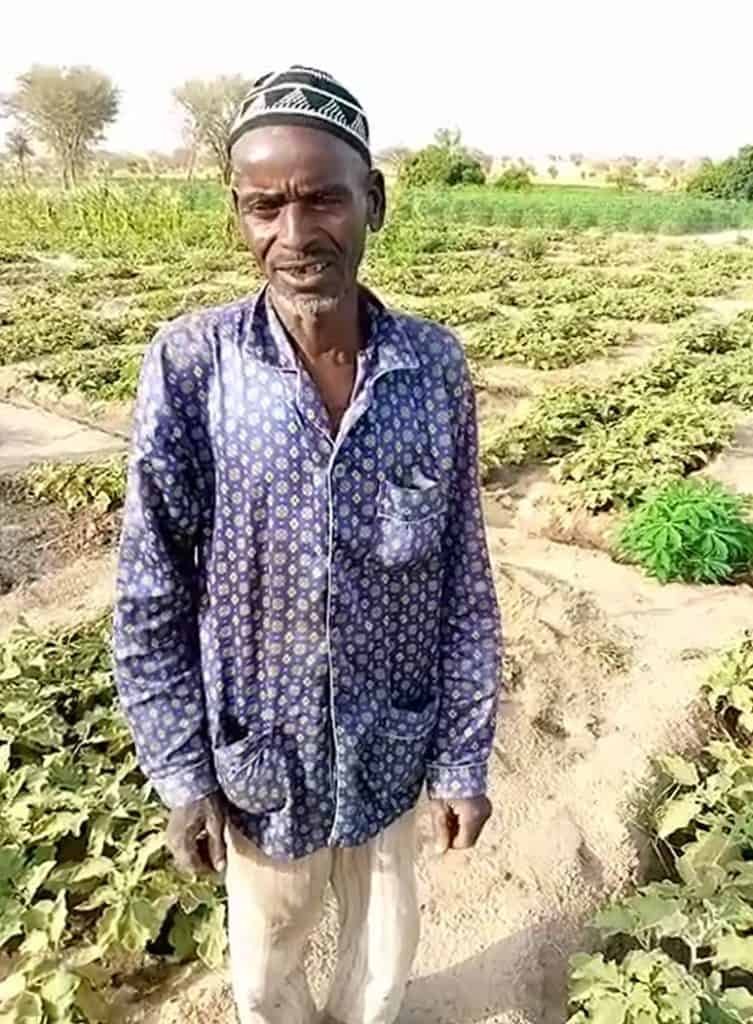 Ibrahim proudly stands before his family’s flourishing garden In Niger.
