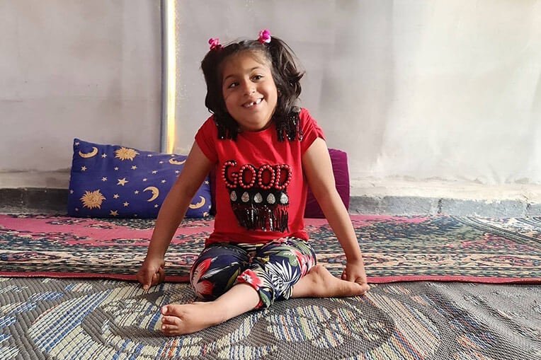 Through physical therapy provided by Samaritan’s Purse, Fatima is learning to overcome her congenital condition that limits the use of her legs.