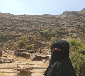 Aya, pictured here in her village, where access to water is a daily struggle