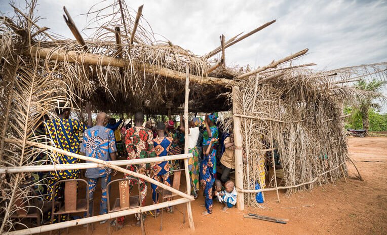 Many people attend services in a thatch hut constructed in a field donated by the village leaders.