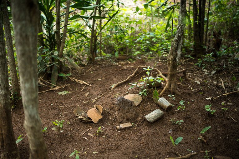 Broken pots and other artifacts in a grove of trees mark the trail leading to Ogouleroun’s home.