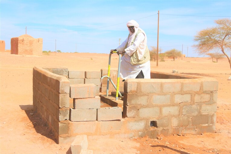 Aboubacar Amadou draws water from the borehole rehabilitated by our wash teams in Niger.