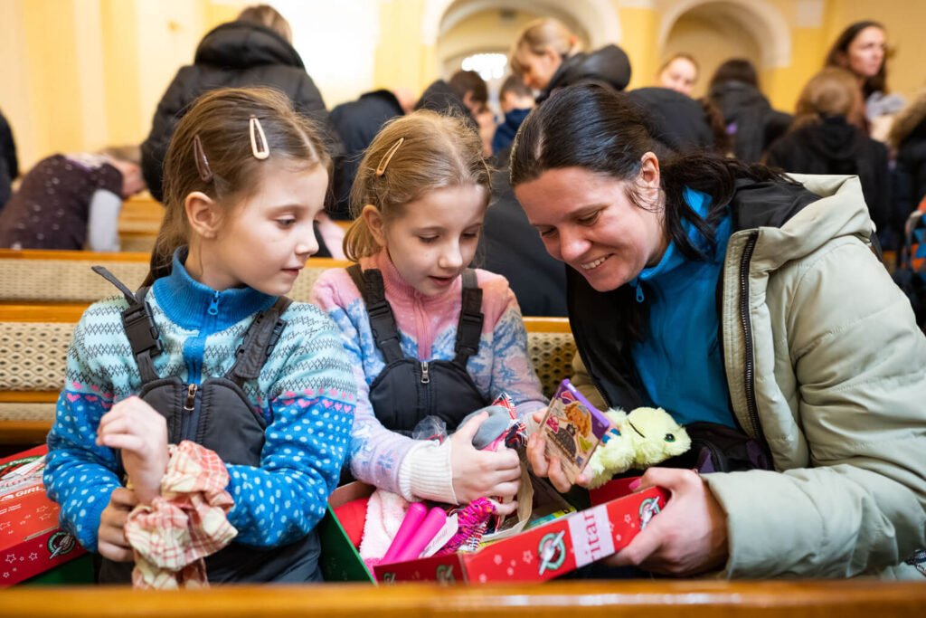 Alina (at right) enjoys looking at the gifts her daughters received through Operation Christmas Child.