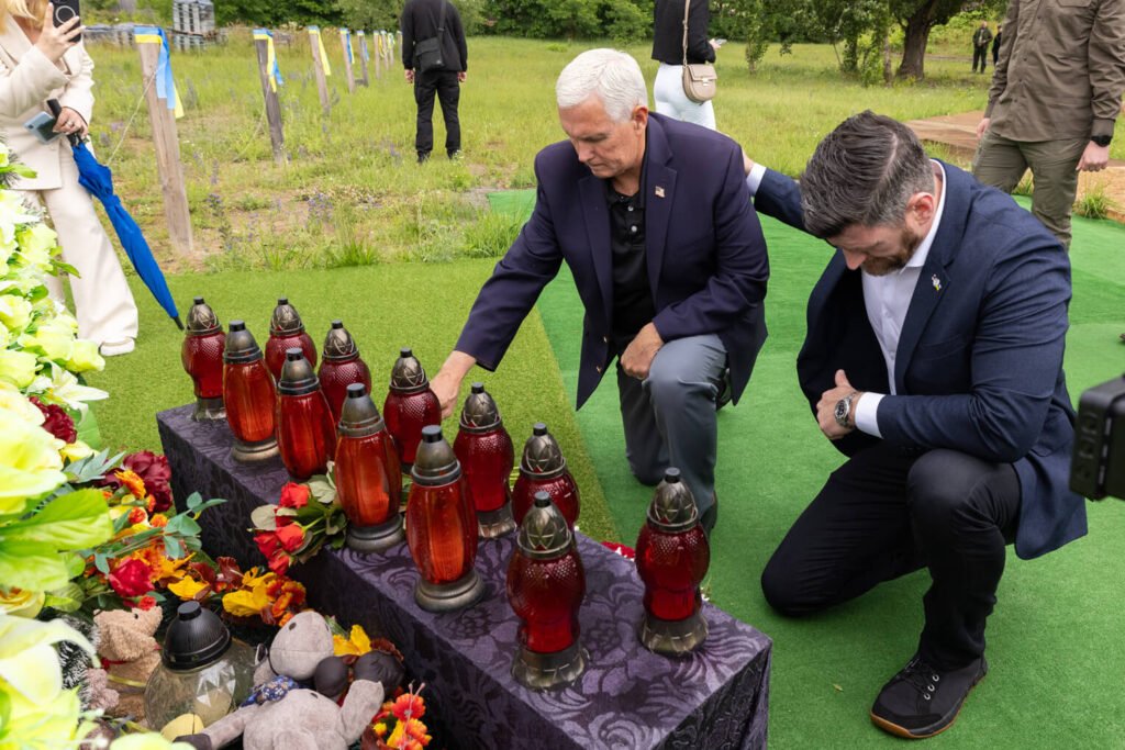 Graham and Pence placed flowers at a memorial for those killed in the war with Russia.